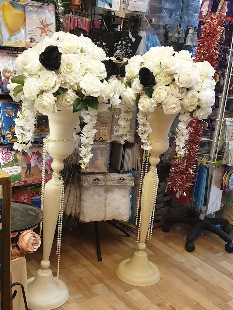 White floral stands for christening decor at Anne's Florist.