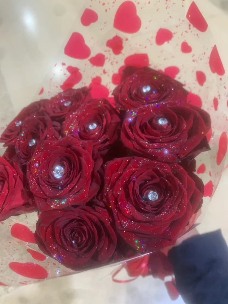 Vibrant birthday bouquet of red roses created at Anne's Florist.