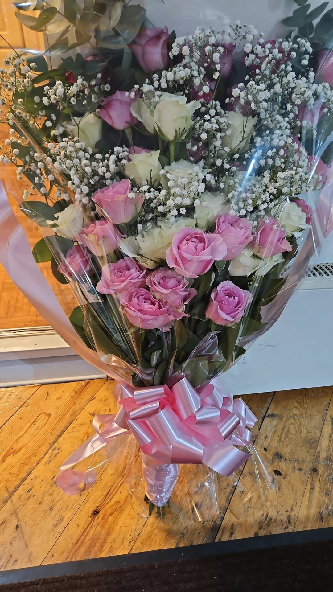 Tall pink and white rose presentation bouquet with gypsophila and pink bow.